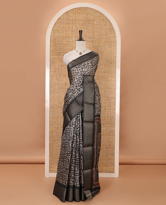 Chikku maze-like printed semi-jute saree, contrast geometric zari border, Madhubani-style animals printed pallu, & black blouse of print & zari work