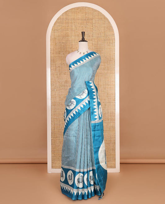 Cream-blue vertically striped khadi cotton saree, contrast Pichwai cow printed temple border, Pichwai cow print pallu, and jaal printed blouse