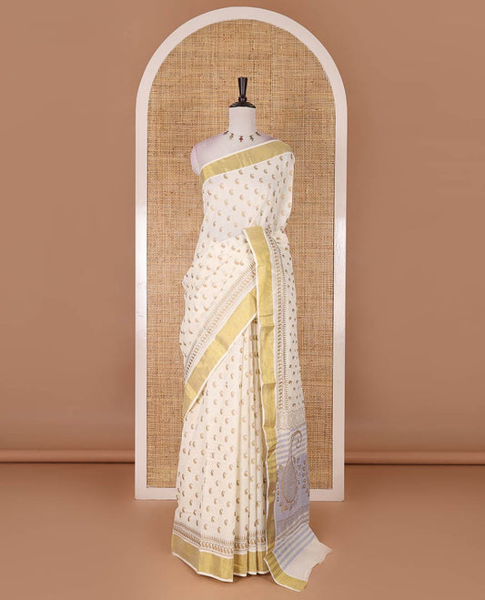 Cream manga butta golden foil printed Kerala cotton saree, zari border, pallu of paisley motifs, and a matching blouse