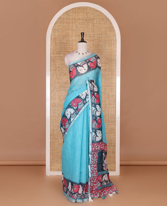 Blue mirror thread embroidered linen saree, contrast kalamkari peacock printed border, pallu of kalamkari peacock and human figurines print, and printed blouse