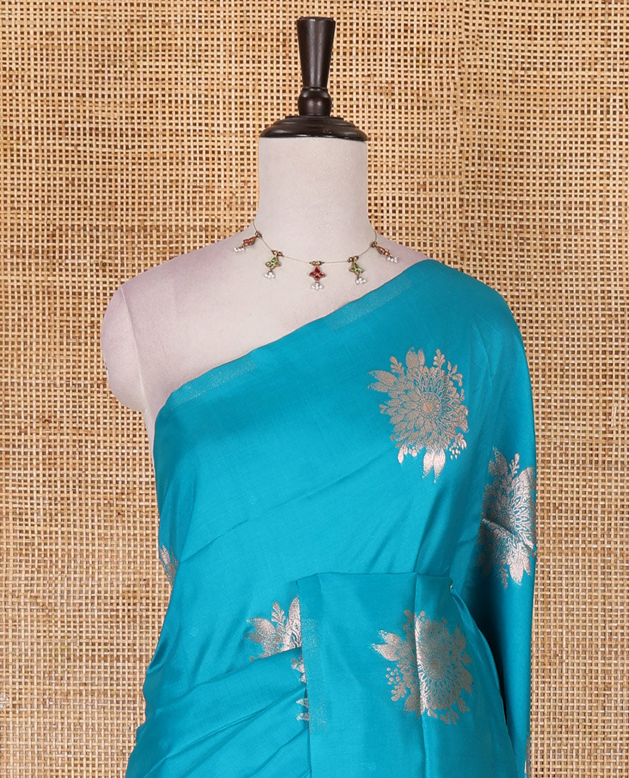 Borderless rama blue floral motifs steeped elite soft silk saree, contrast lotus-like motifs pallu, and contrast buttas blouse