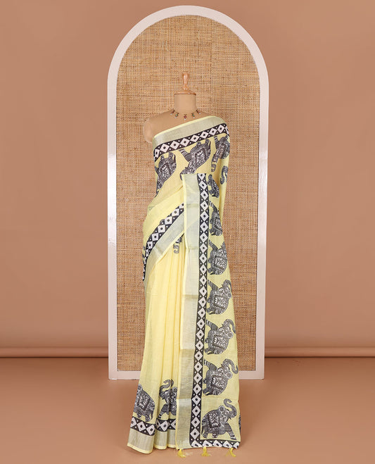 Yellow plain linen cotton saree, silver zari border of elephant motifs print, elephant motifs pallu, and a contrast elephant motifs printed blouse