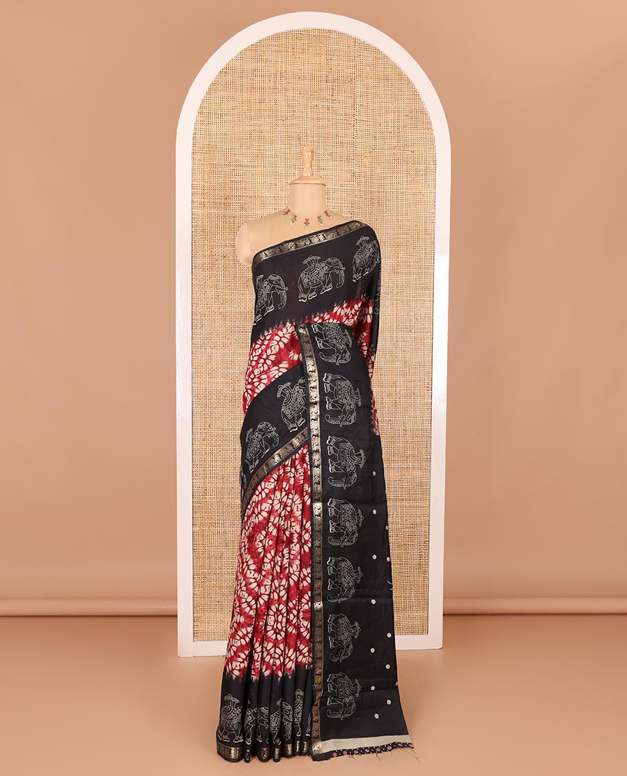 Red shibori printed muslin cotton saree, contrast zari border of elephant motifs print, big elephant printed pallu, and a contrast printed blouse