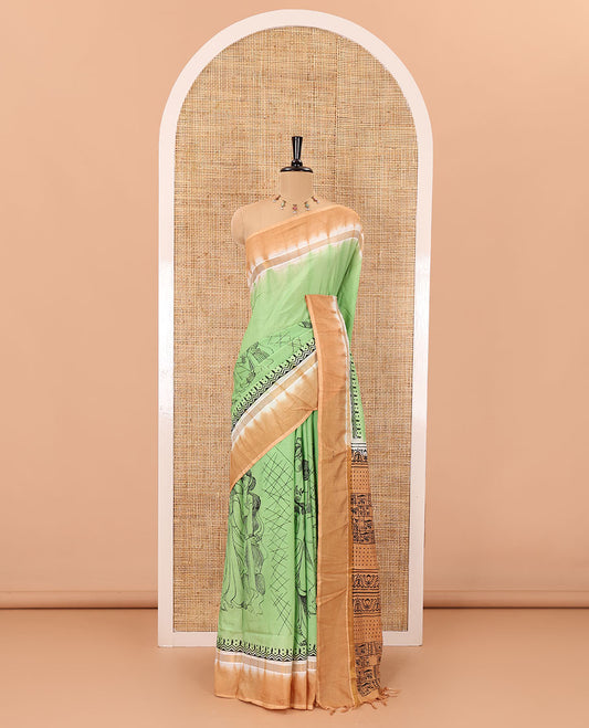 Green South Indian women motifs printed chennur silk saree, contrast plain border, printed pallu, and a contrast plain blouse