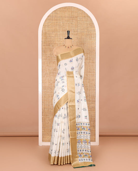 Half-white buttas with warli village motifs printed dola silk saree, contrast traditional zari border of paisleys, warli printed pallu, and a contrast printed blouse