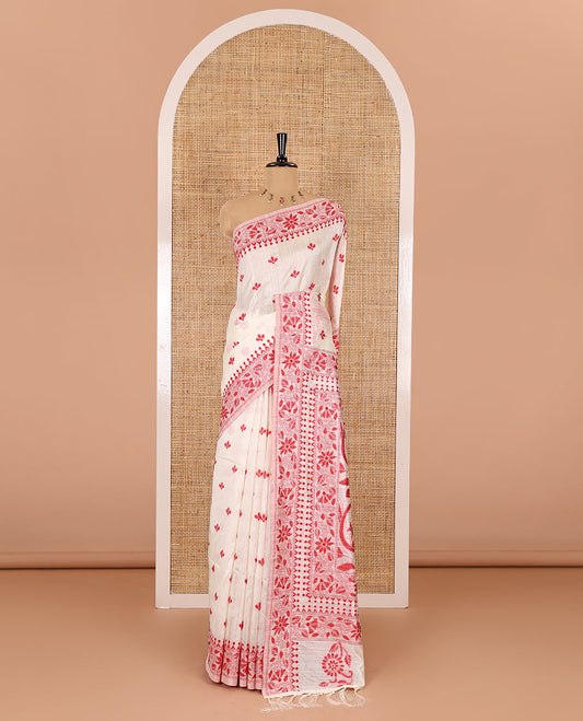 Half-white and red floral thread buttas woven jute cotton saree, floral thread weave border, floral-paisley weave pallu, and a matching blouse