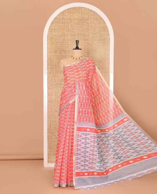 Borderless tomato pink ikkat jaal patterned linen cotton saree, contrast ikkat jaal patterned pallu and ikkat buttas blouse