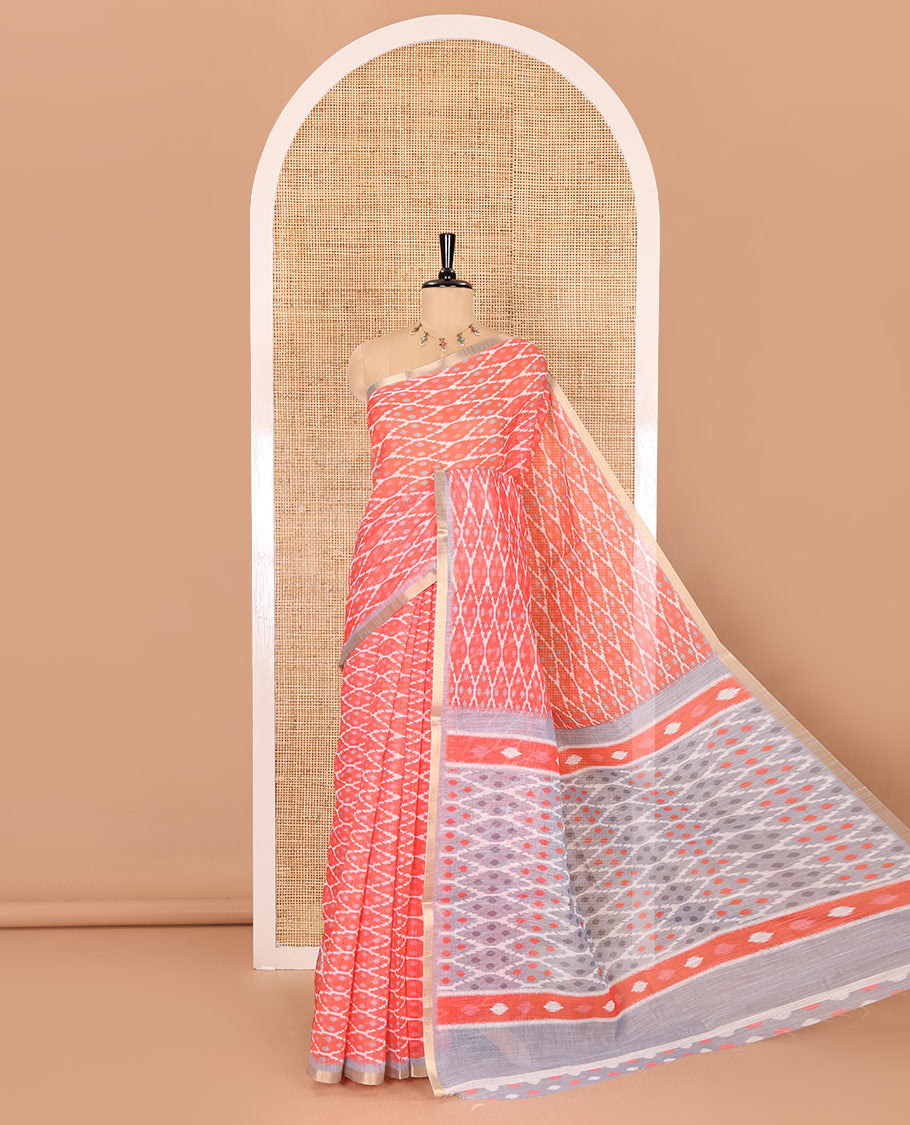 Borderless tomato pink ikkat jaal patterned linen cotton saree, contrast ikkat jaal patterned pallu and ikkat buttas blouse