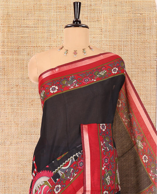 Black human figurines printed muslin cotton saree, contrast floral-peacock printed border of piping work, kalamkari printed pallu, and a contrast blouse of flower motifs print