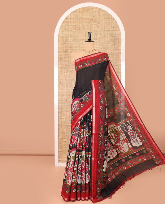 Black human figurines printed muslin cotton saree, contrast floral-peacock printed border of piping work, kalamkari printed pallu, and a contrast blouse of flower motifs print