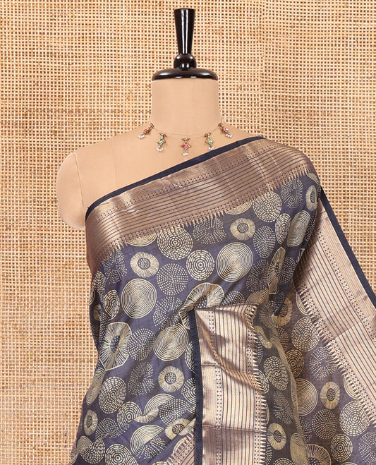 Navy blue lotus-leaf style printed semi-tussar saree, traditional zari border, zari striped pallu, and a matching blouse