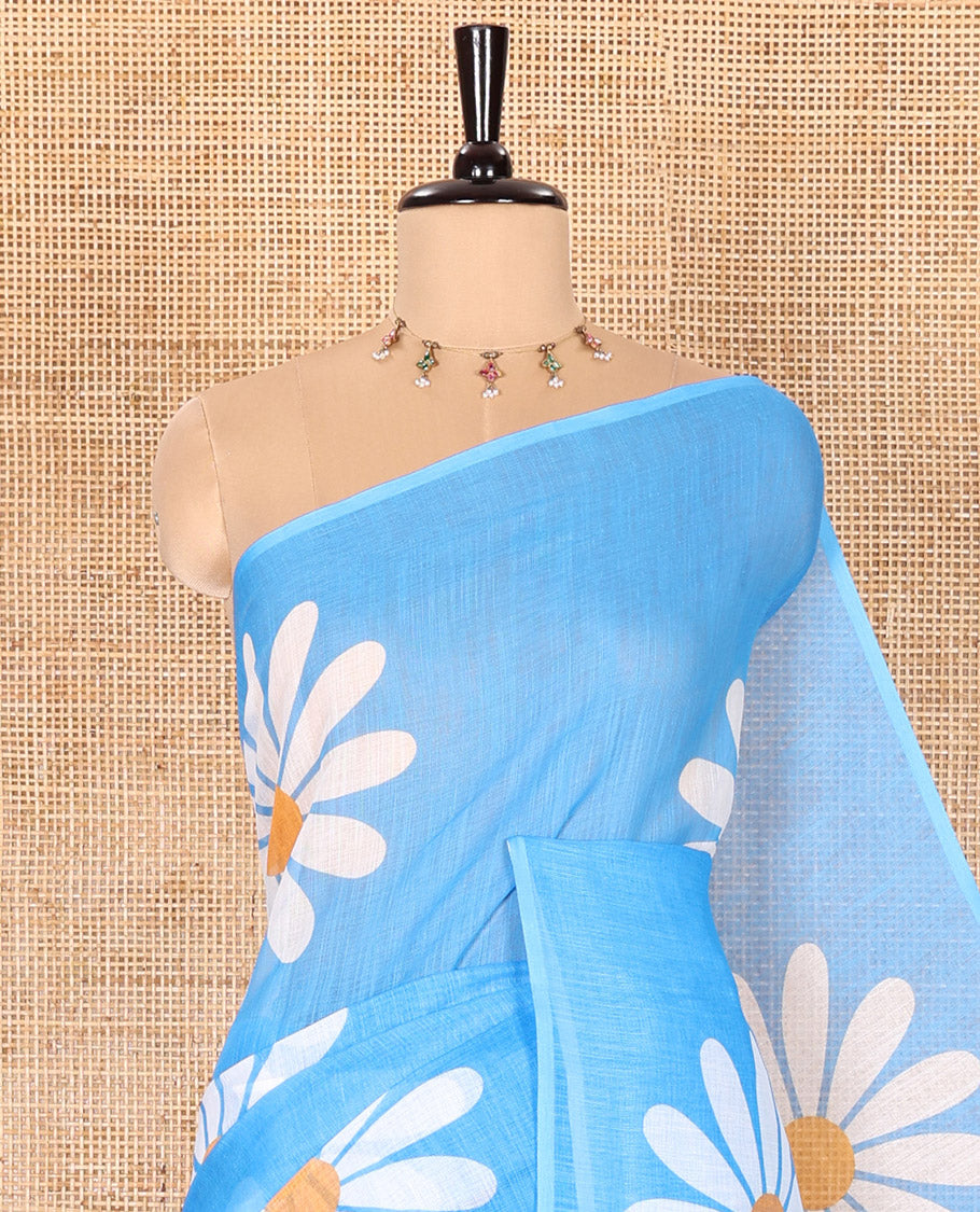 Borderless Blue Linen Saree Beautified with Big Daisy Flower Motifs Printed All Over the Body and Pallu, Complemented by a Contrast Blouse Printed with Daisy Flower Motifs