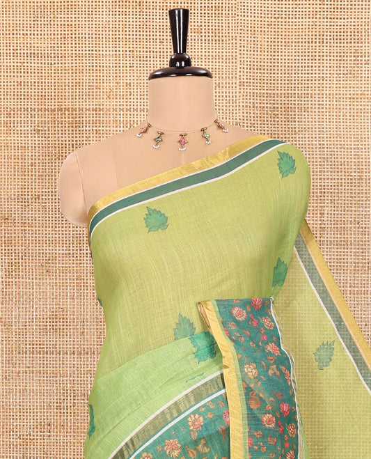 Parrot Green Linen Saree Highlighted with Leaf Motifs All Over Its Body, Complemented by a Contrast Floral Vine Printed Border, Pallu Mirrors the Floral Vine Print, and Paired with a Contrast Floral Printed Blouse