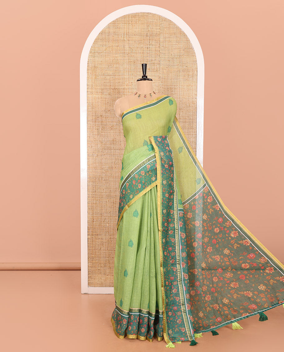 Parrot Green Linen Saree Highlighted with Leaf Motifs All Over Its Body, Complemented by a Contrast Floral Vine Printed Border, Pallu Mirrors the Floral Vine Print, and Paired with a Contrast Floral Printed Blouse