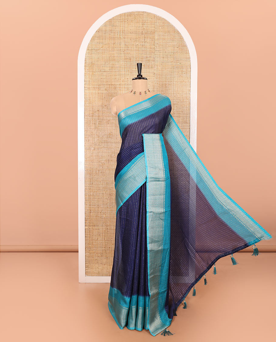Navy Blue and Blue Dola Silk Saree Subtly Sparked with Vertical Golden Stripes Running All Over Its Body, Complemented by a Contrast Traditional Zari Design Woven Border, Subtly Striped Pallu, and a Contrast Buttas Woven Blouse