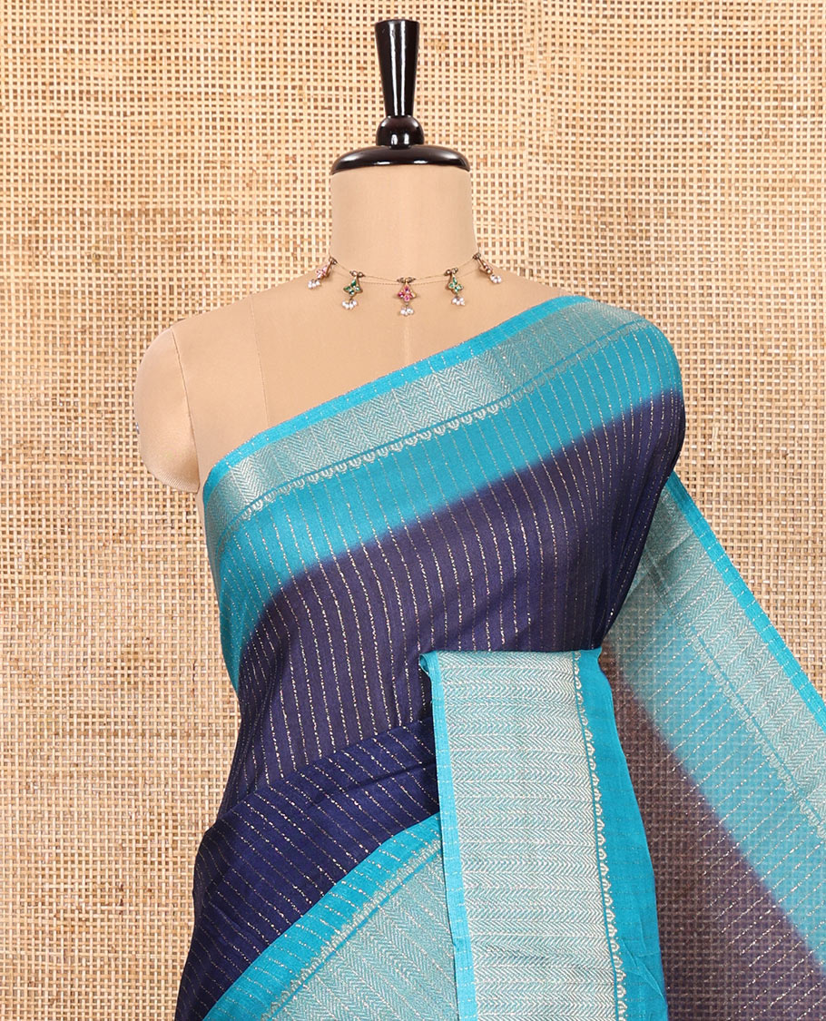 Navy Blue and Blue Dola Silk Saree Subtly Sparked with Vertical Golden Stripes Running All Over Its Body, Complemented by a Contrast Traditional Zari Design Woven Border, Subtly Striped Pallu, and a Contrast Buttas Woven Blouse