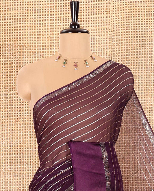 Violet Viscose Georgette Saree Gleamed with Horizontal Golden Zari Stripes All Over Its Body, Accentuated by a Satin Plain Border, a Self Pallu Featuring the Same Horizontal Stripes, and Paired with a Running Blouse