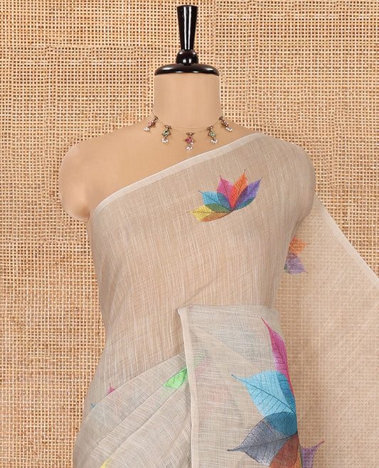 Borderless Chikku Linen Cotton Saree, Artfully Detailed with Kaleidoscope-Colored Flower-Shaped Leaf Motifs Print, Pallu Mirrors the Same Print, and Paired with a Matching Printed Blouse