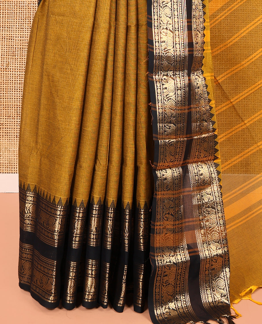 Mustard Plain Chettinad Cotton Saree, Complemented by a Contrast Rettai Pettu Temple Antique Gold Zari Border of Coin, Elephant, and Peacock Designs, Subtly Striped Pallu, and Paired with a Matching Blouse