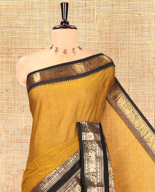 Mustard Plain Chettinad Cotton Saree, Complemented by a Contrast Rettai Pettu Temple Antique Gold Zari Border of Coin, Elephant, and Peacock Designs, Subtly Striped Pallu, and Paired with a Matching Blouse