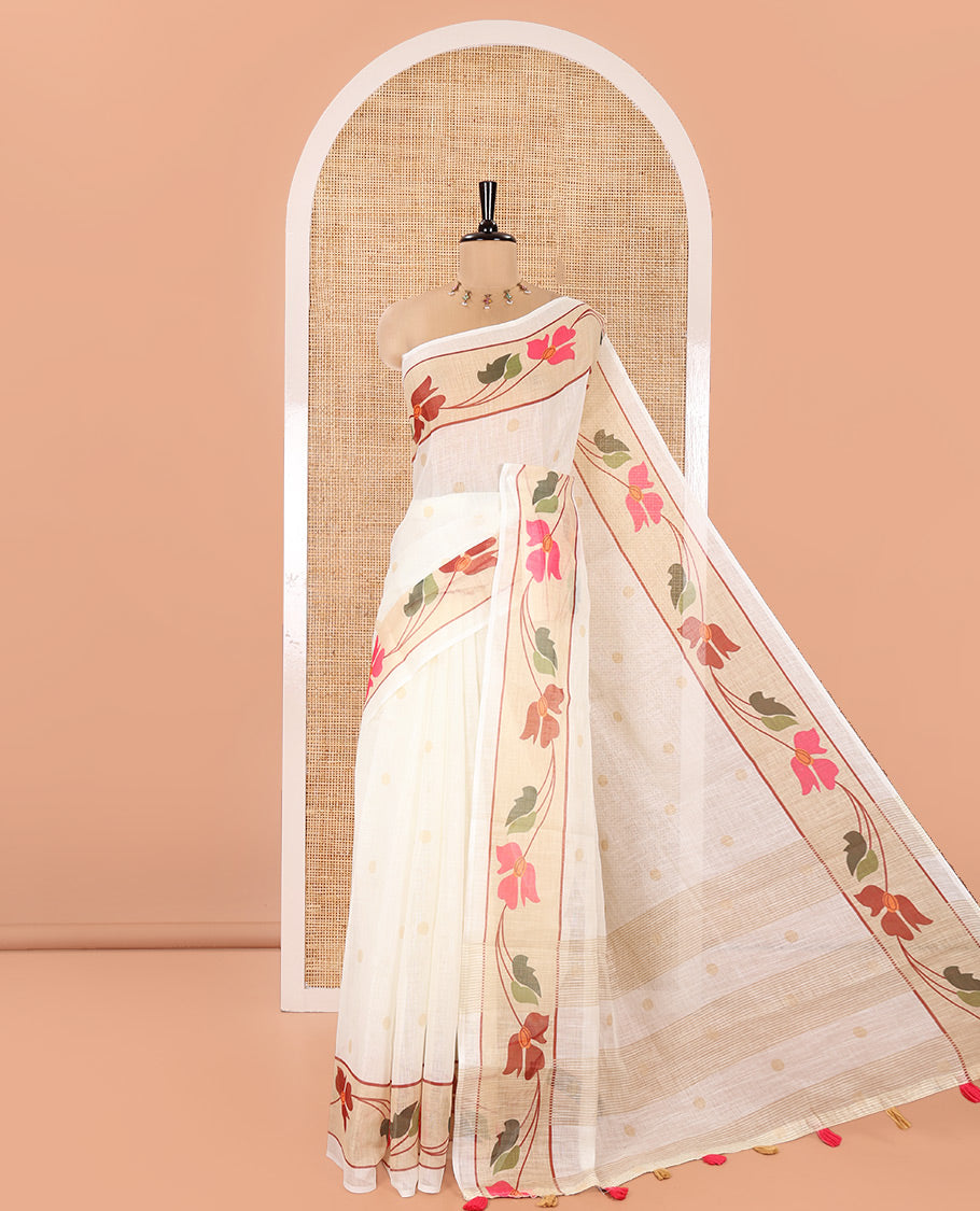 Cream Linen Cotton Saree, Subtly Sparkled with Zari Buttas All Over Its Body, Highlighted by Contrast Floral Creeper Design Border, Subtle Pallu and Paired with a Striped Blouse