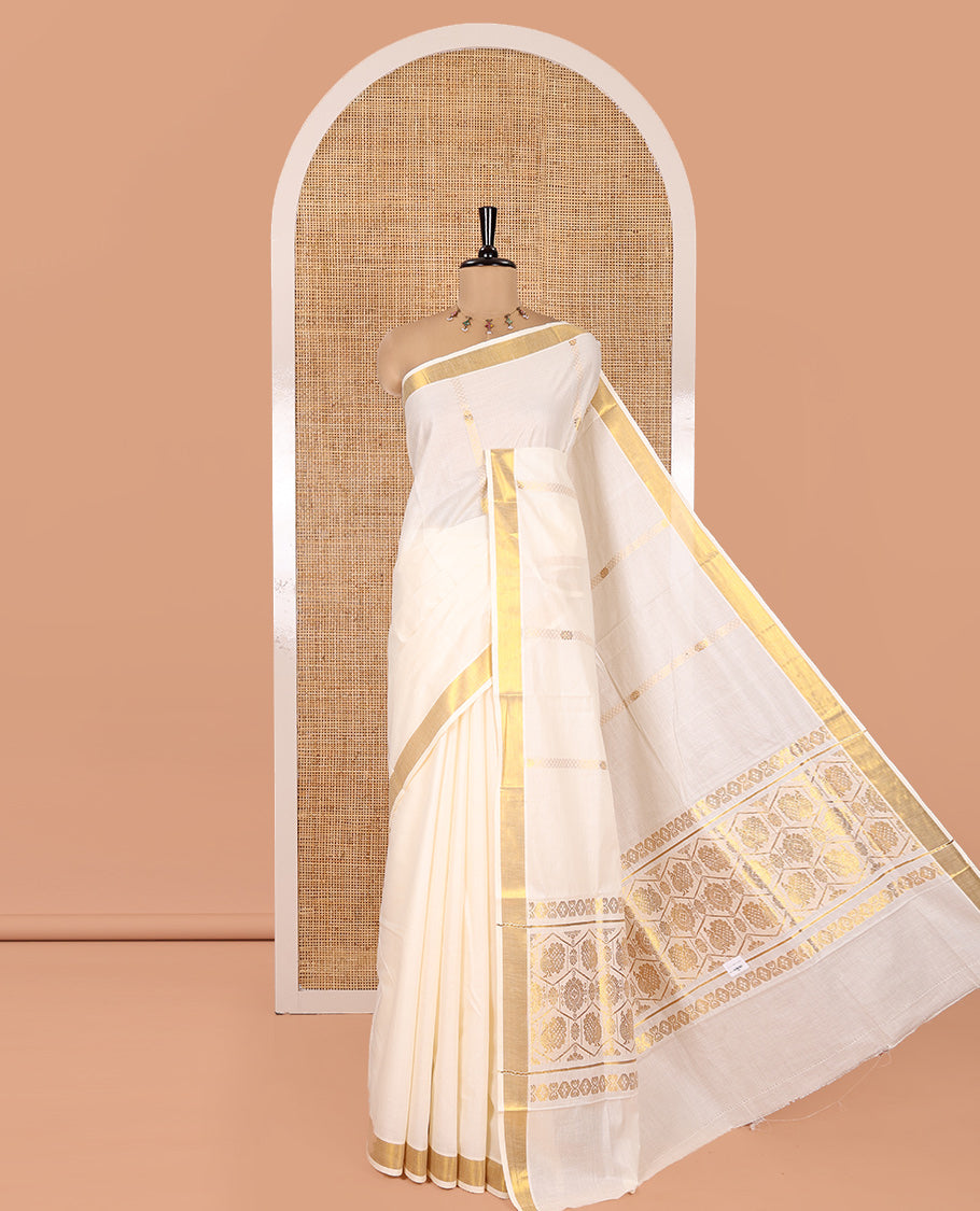 Cream Kerala Cotton Saree, Gleamed Up with Zari Stripes, a Zari Border, a Pallu of Chakram-Peacock Designs, and a Matching Blouse