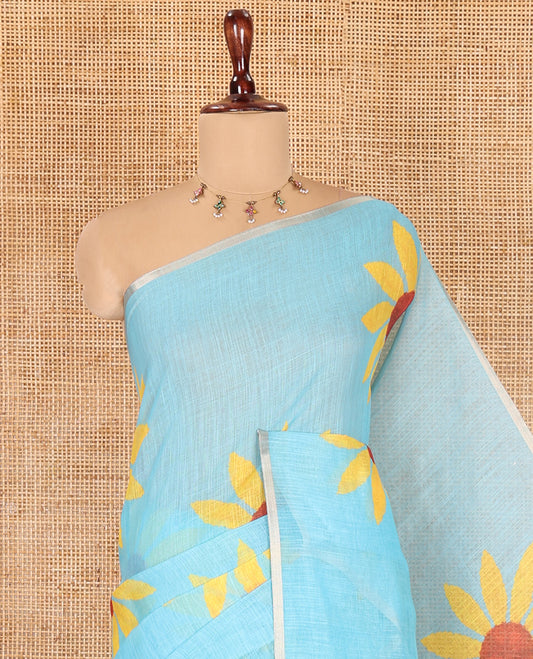 Sky Blue Linen Cotton Saree, Impeccably Styled with Sunflower Motifs Print, a Piping Border, and a Contrast Blouse
