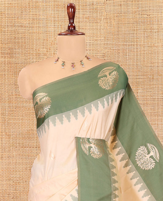Cream Elite Soft Silk Saree, Woven with Zari Buttas, a Contrast Tree Motifs Temple Border, Paithani-Style Woven Pallu, a Contrast Blouse