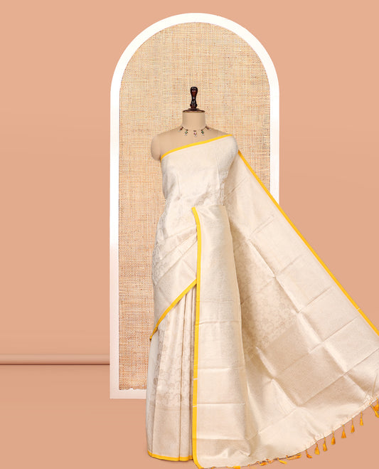 Off-White-Yellow Semi-Silk Saree, Adorned with Floral Jacquard Design, a Zari Paisley Border, and a Contrast Blouse