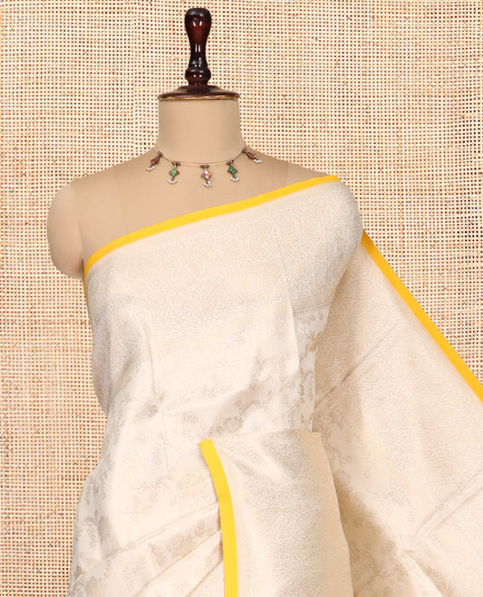 Off-White-Yellow Semi-Silk Saree, Adorned with Floral Jacquard Design, a Zari Paisley Border, and a Contrast Blouse