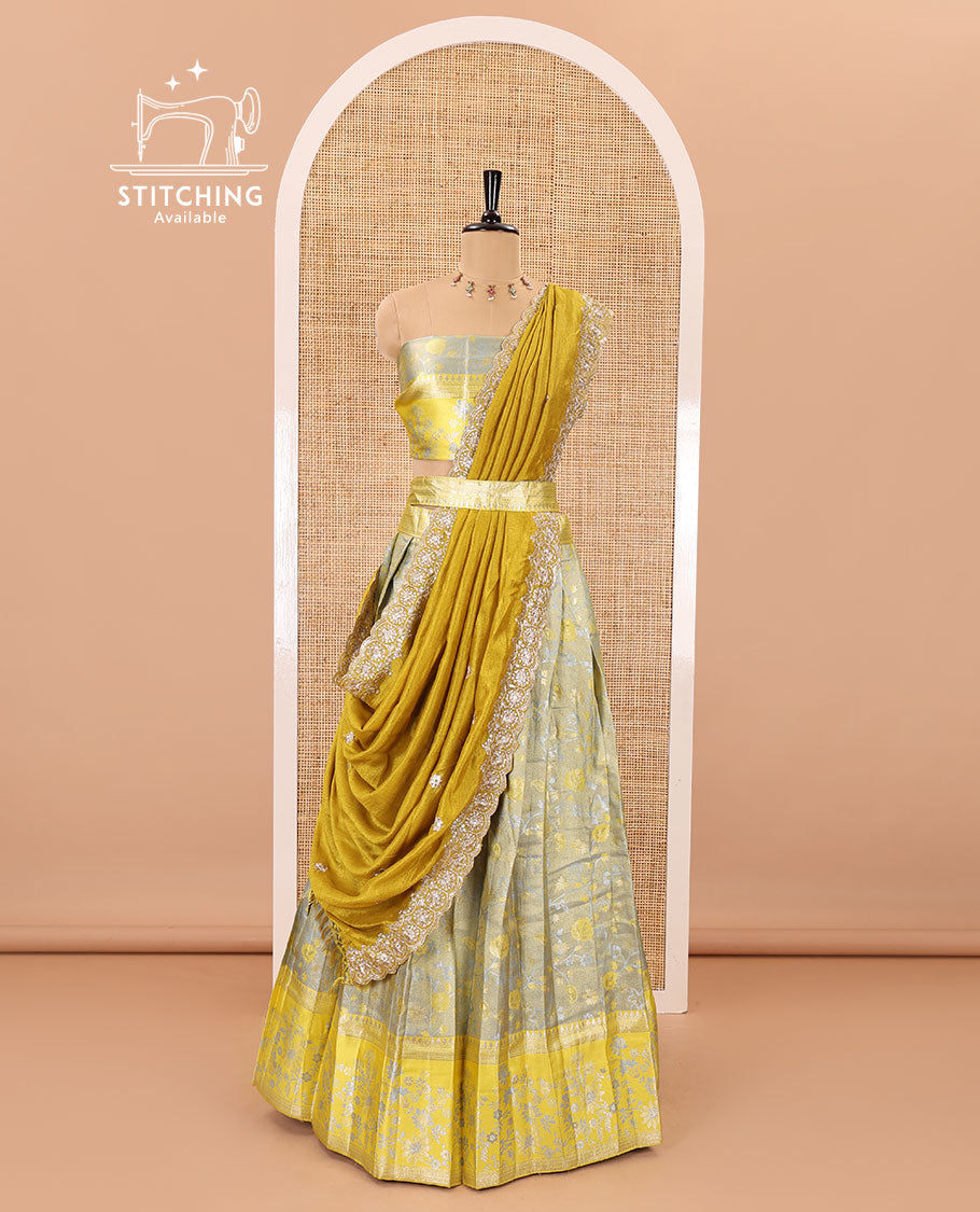 Grey banarasi half-saree, floral jaal thread weave with contrast floral thread bordered skirt, a matching blouse, and scallop embroidered dhavani with belt
