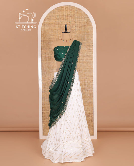 Cream-green half-saree, gold chevron striped nylon viscose crepe skirt, contrast diamond buttas blouse, and  a contrast scallop floral-theme embroidered dhavani