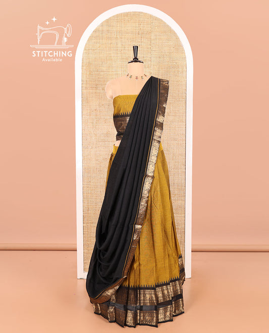 Mustard-Black Chettinad Cotton Half-Saree Featuring a Plain Skirt, Highlighted with a Contrast Peacock-Elephant Motifs Woven Rettai Pettu Zari Border, a Subtly Woven Matching Blouse, and a Vichitra Silk Contrast Traditional Zari-Bordered Dhavani