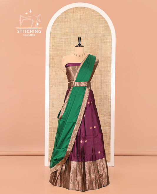 Purple and Green Semi-Banarasi Half-Saree, Elevated with Zari Buttas on Its Skirt, Complemented by a Contrast Traditional Zari-Design Border, Paired with a Matching Blouse, and a Contrast Satin Georgette Zari-Bordered Dhavani