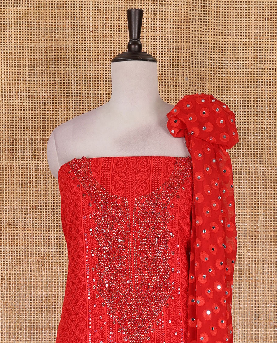 Red material churidar set, stone work with Schiffli style embroidered georgette top, American Crape bottom, and polka dotted printed mirror work dupatta