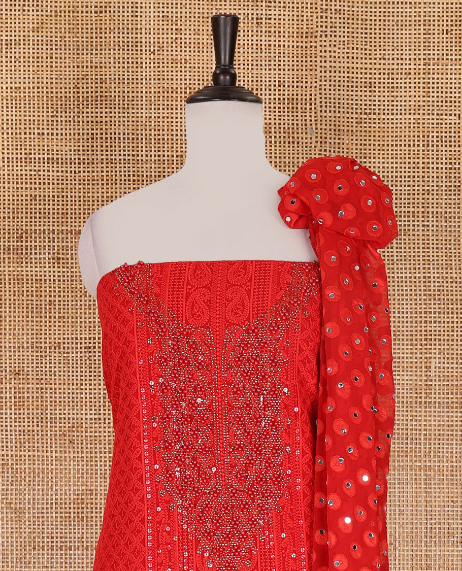 Red material churidar set, stone work with Schiffli style embroidered georgette top, American Crape bottom, and polka dotted printed mirror work dupatta