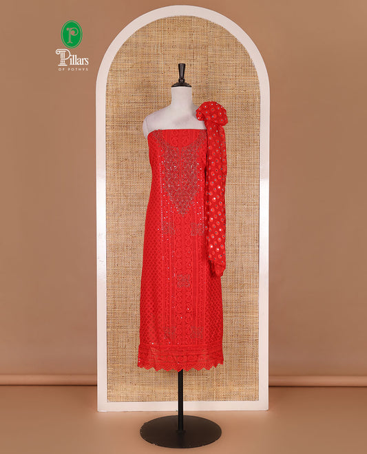 Red material churidar set, stone work with Schiffli style embroidered georgette top, American Crape bottom, and polka dotted printed mirror work dupatta