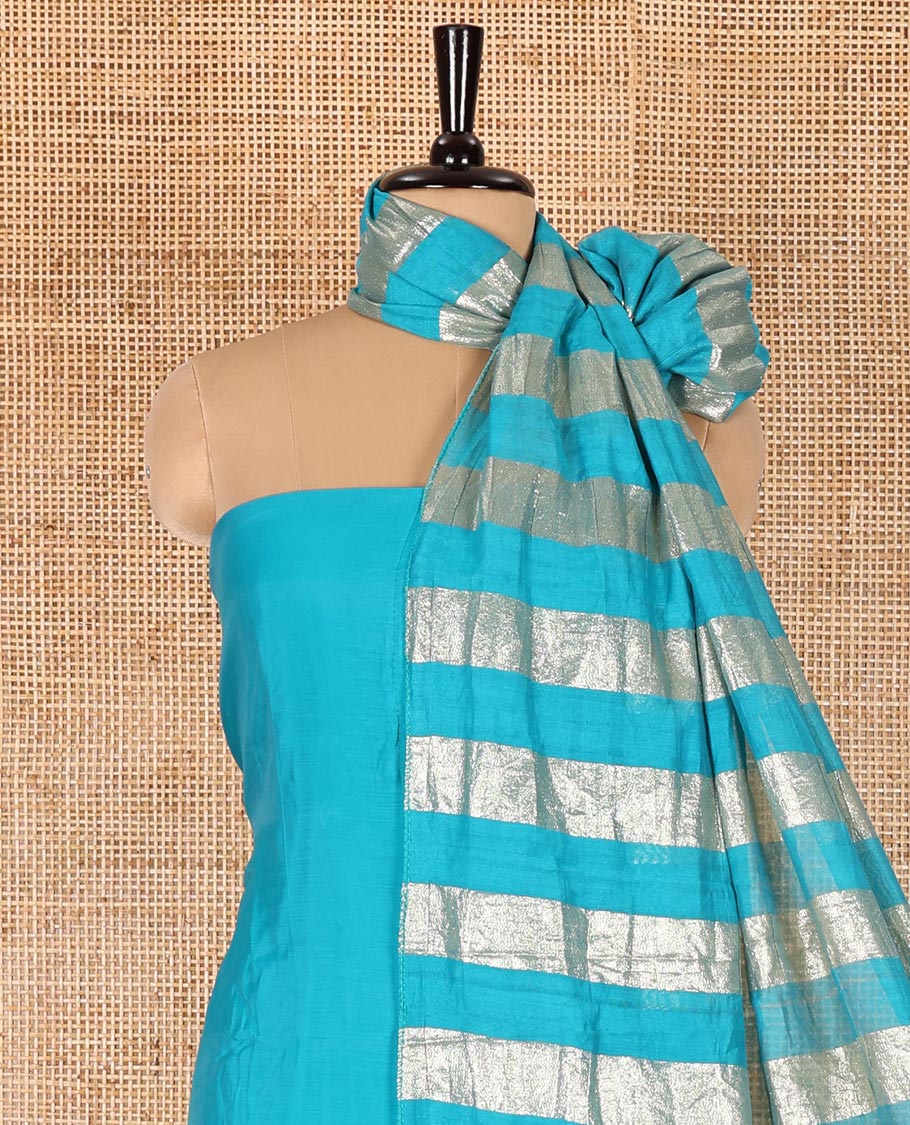 Blue material chudidar set, plain with pom-pom tasseled mul chanderi top, a matching bottom, and organza dupatta of stripes