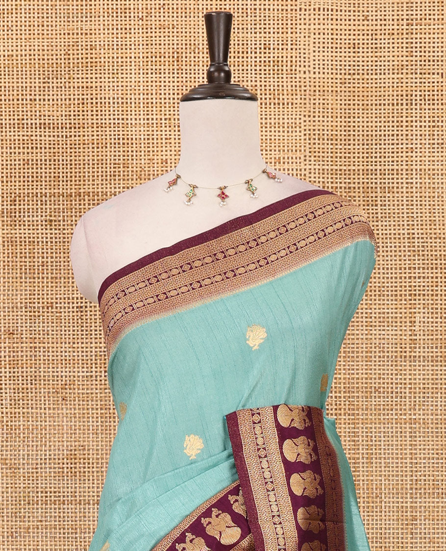 Sea blue peacock buttas dola silk saree, contrast rudraksham & iruthalai pakshi border, intricate pallu & contrast jacquard blouse