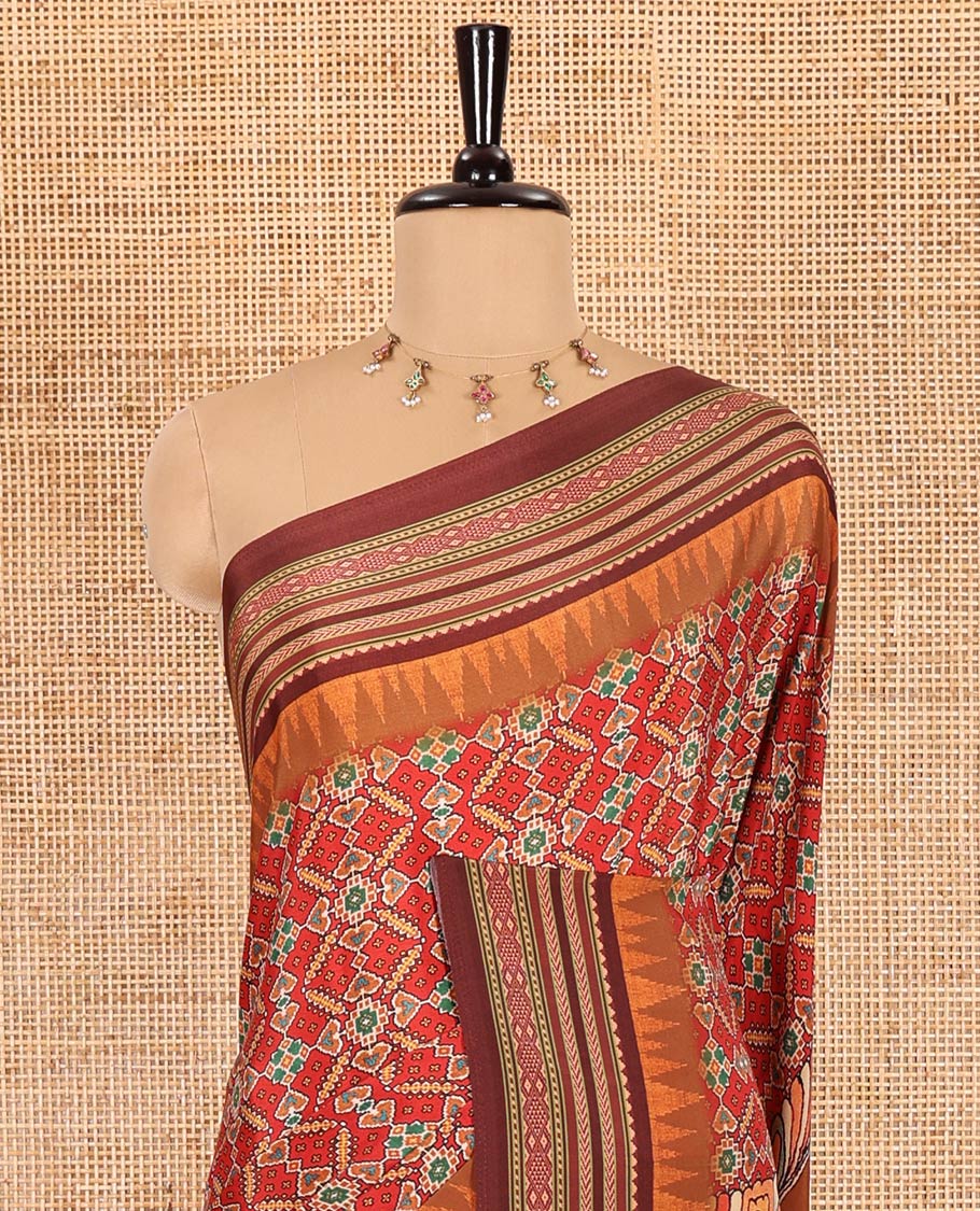 Tomato red patola style geometric printed Italian Crepe saree, contrast temple ikkat printed border, Kalamkari printed pallu, and a printed bordered blouse