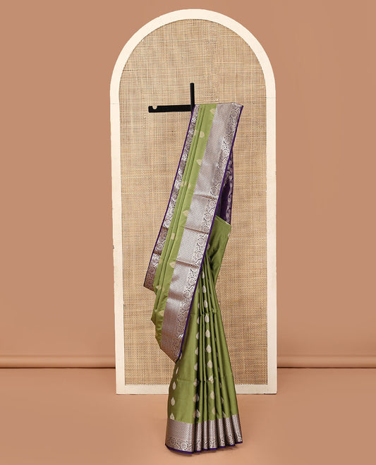 Olive green zari buttas soft silk saree, contrast diamond and floral creeper border, and pallu of lotus floral designs