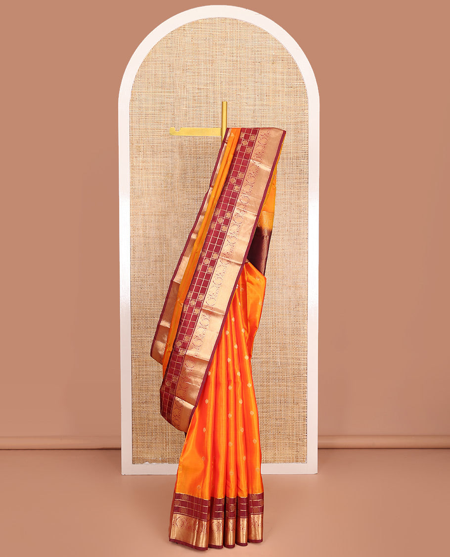 Orange Vasundhara Lite-Silk Mix Saree, Enthralled with Zari Buttas All Over Its Body, Complemented by a Contrast Annam Chakram Enclosed Checked Border of Kamalam, Manga, and Yaanai Designs, Grand Pallu of Jaal Designs, and Paired with a Contrast Blouse