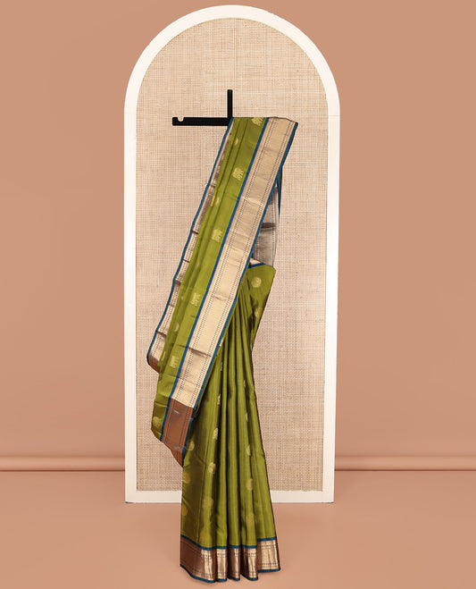 Green Vasundhara Lite Silk Mix Saree, Elegantly Highlighted with Zari Buttas on Its Body, Complemented by a Contrast Border of Thilakam, Muthu, Mayil Kann, Neli, and Manga Designs, Grandly Woven Pallu, and Paired with a Contrast Blouse