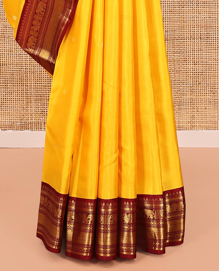 Yellow Vasundhara Silk Saree, Subtly Sparkled with Buttas All Over Its Body, Complemented by a Contrast Border of Thilakam, Neli, Kathir, Mayil, Yaanai, and Mayil Kann Designs, Grand Jaal Pallu, and Paired with a Contrast Blouse