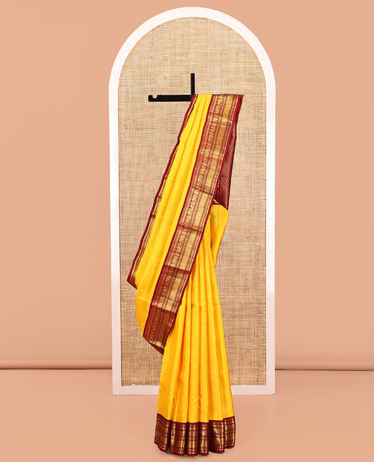 Yellow Vasundhara Silk Saree, Subtly Sparkled with Buttas All Over Its Body, Complemented by a Contrast Border of Thilakam, Neli, Kathir, Mayil, Yaanai, and Mayil Kann Designs, Grand Jaal Pallu, and Paired with a Contrast Blouse