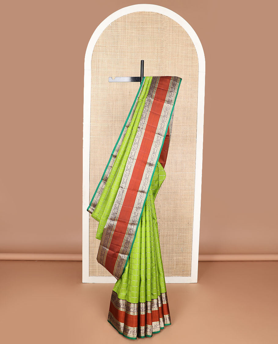 Green checked silk saree with contrast rettai pettu border of thilakam mokku, paun, muthu design & zari design pallu