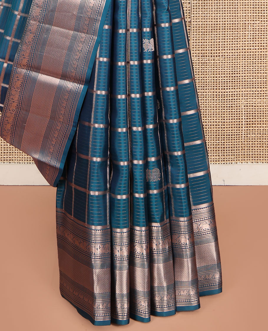 Blue Vasundhara Silk Saree, Enriched with Zari Butta Enclosed Checked Design All Over Its Body, Highlighted by Zari Border of Thilakam Mokku, Muthu, Mayil, Yaanai, and Mayil Kann Designs, Grand Jaal Pallu, and Paired with a Matching Blouse