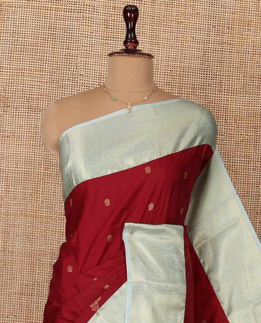 Red Budget Silk Saree, Elegantly Highlighted  with Zari Buttas All Over Its Body, Complemented by a Contrast Traditional Zari Designs Woven Border, Opulently Embellished Pallu, and Paired with a Contrast Blouse