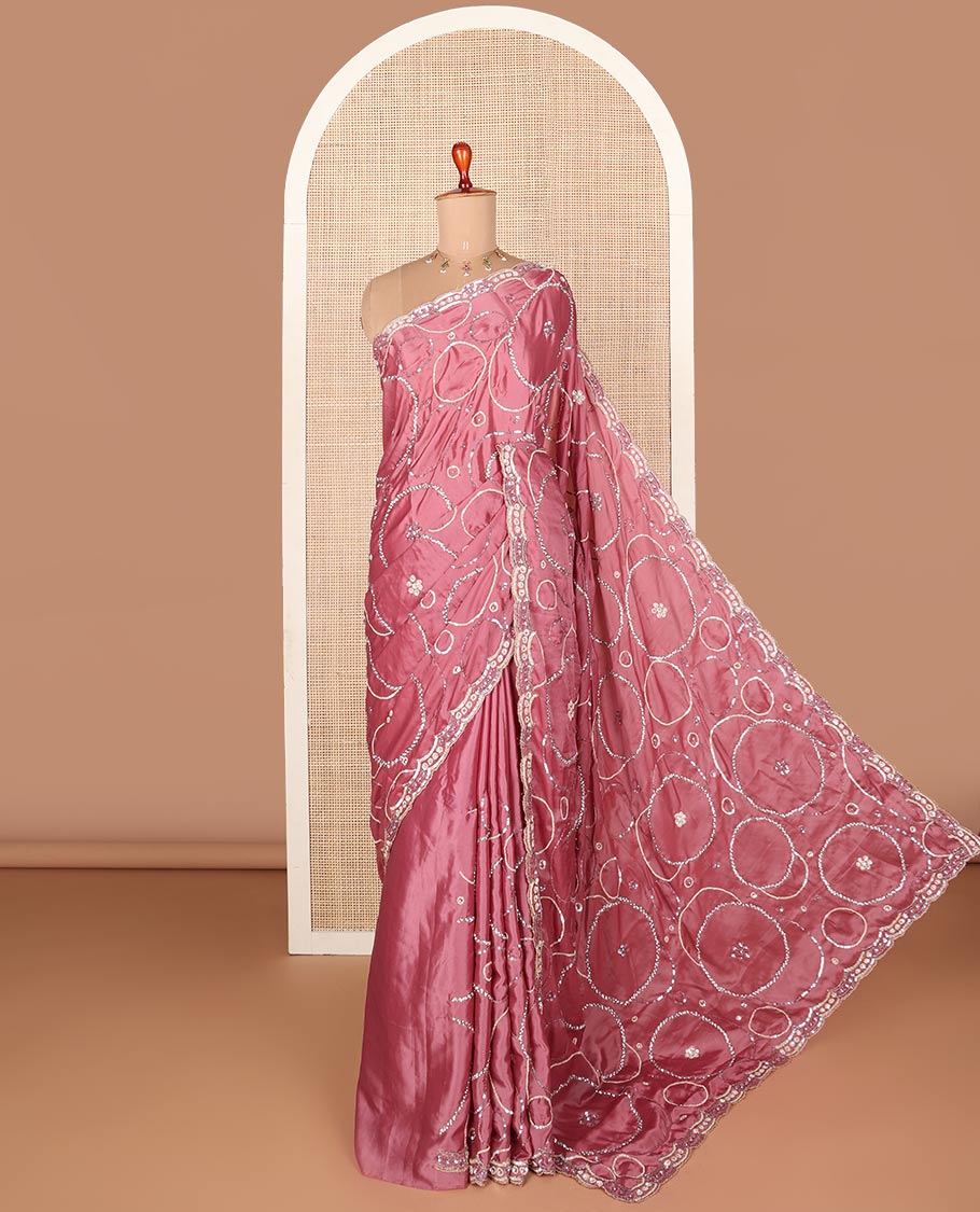 Pink embroidered designer saree features circular-shaped motifs woven in stones & sequins, scallop embroidered border