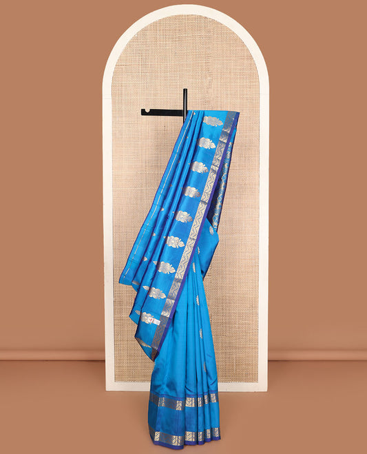 Blue zari buttas Kanchipuram silk saree, one-sided zari border of rekku, banaras, and neli designs, and floral design pallu
